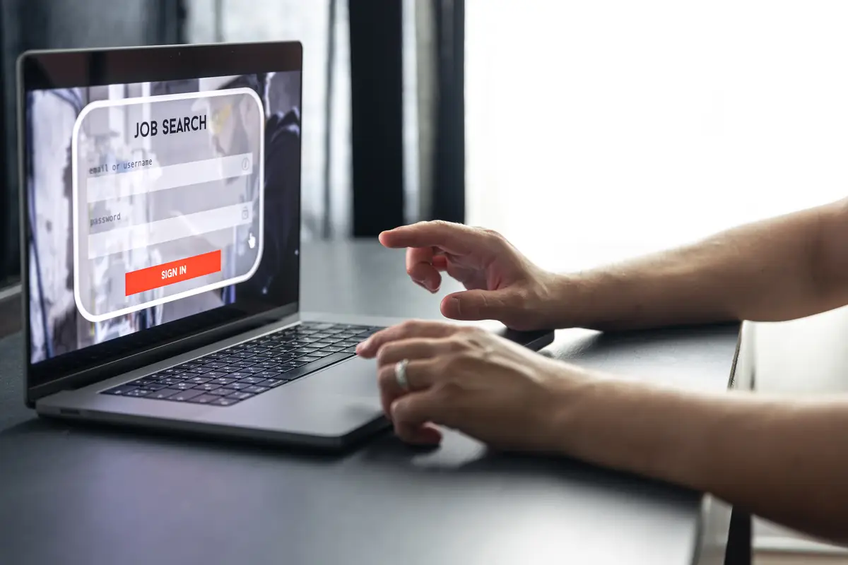 Man working on laptop and information for the searching job employment concept