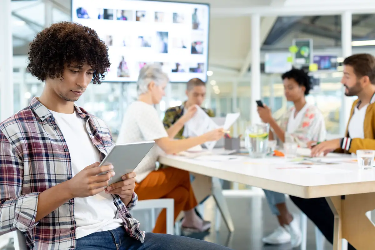 Male fashion designer using digital tablet in the conference room