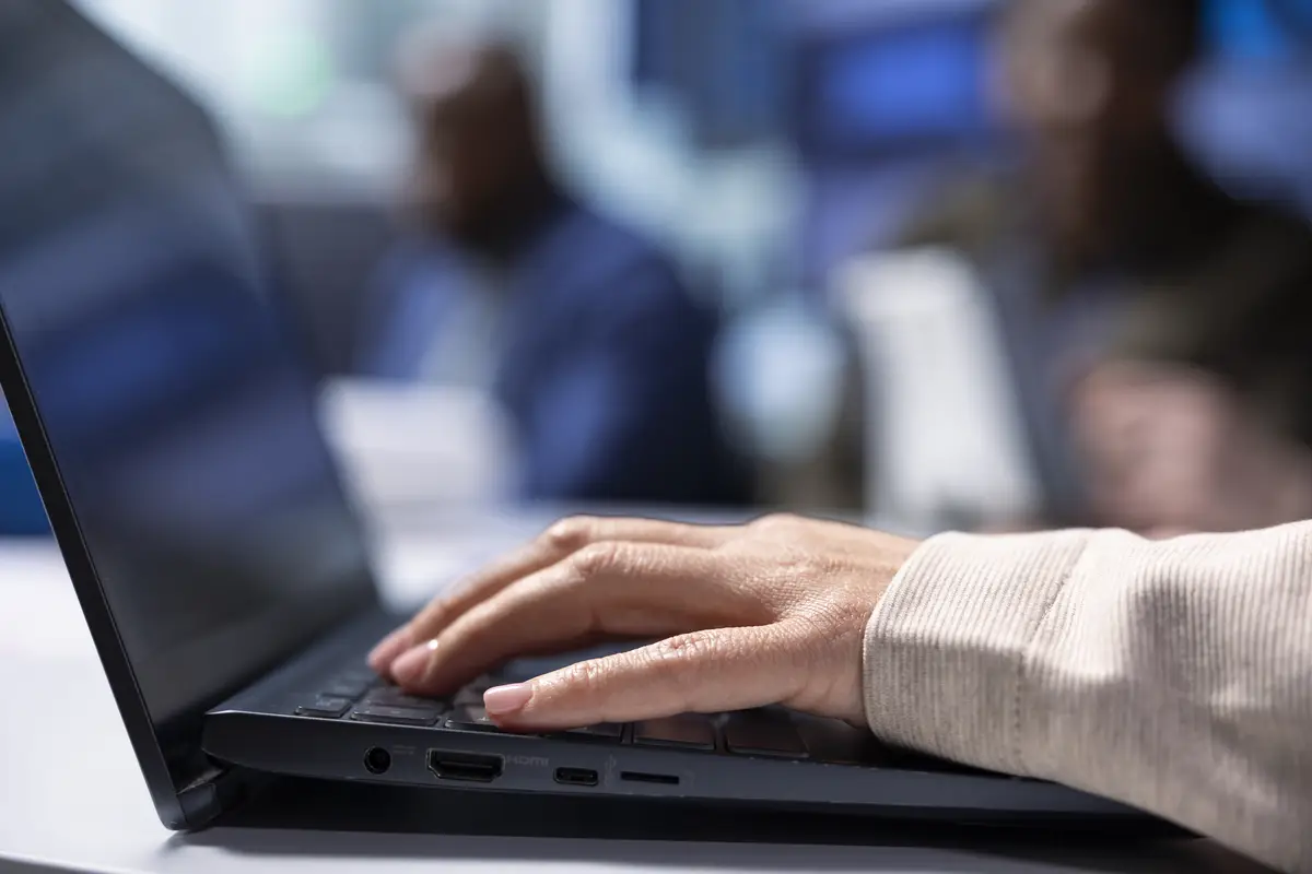 Investors using laptop to do screening before investing in factory