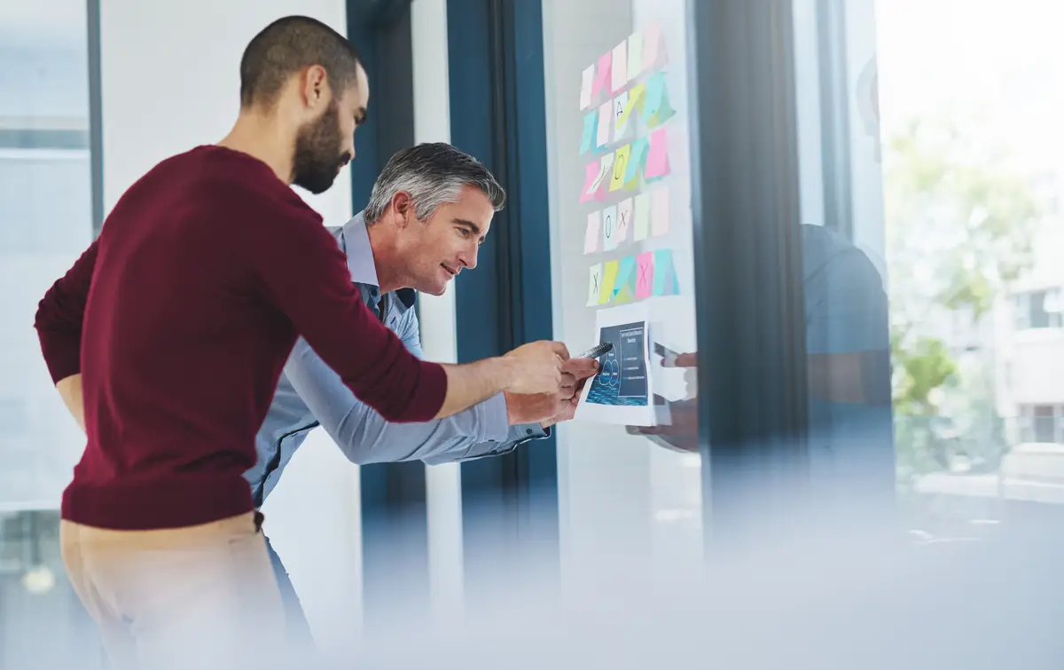 Giving him an explanation Cropped shot of two businessmen working in the office