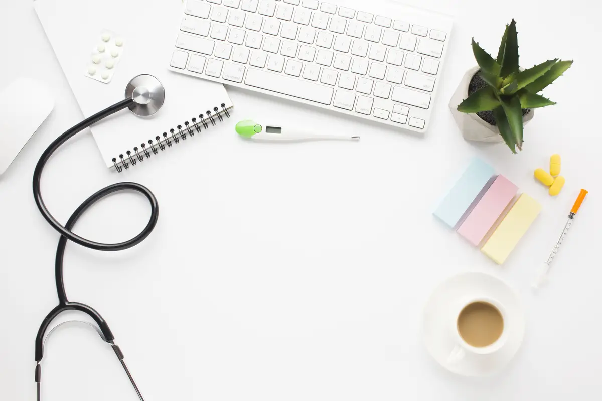 Healthcare tools; medicine; coffee; and succulent plant on white surface