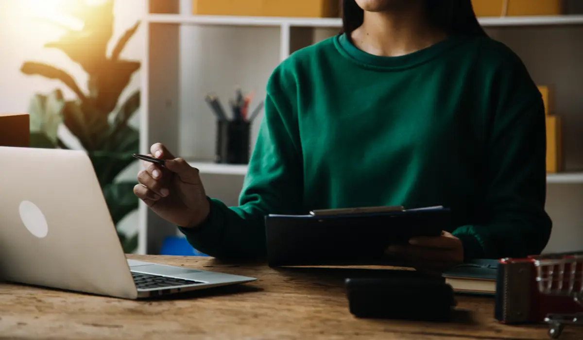 Startup small business entrepreneur or freelance Asian woman using a laptop with box Young success Asian woman with her hand lift up online marketing packaging box and delivery SME concept