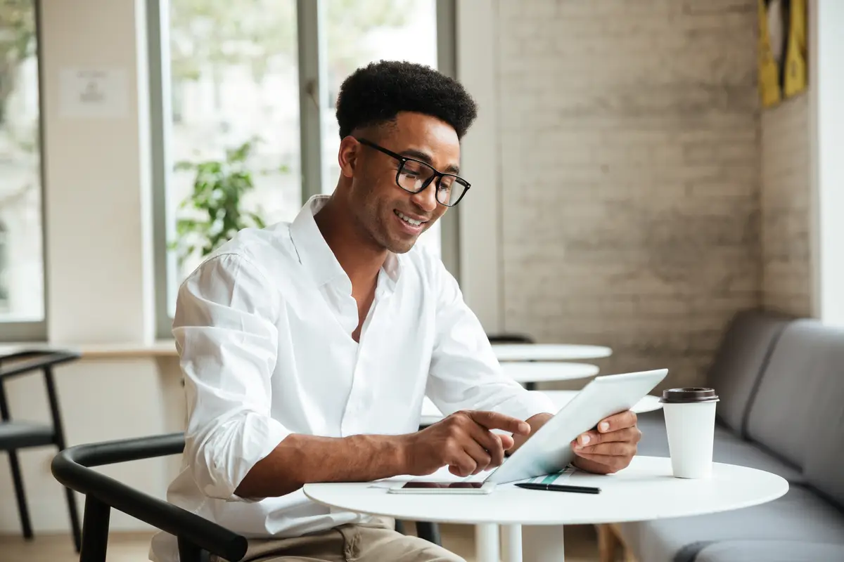 Happy young african man sitting coworking