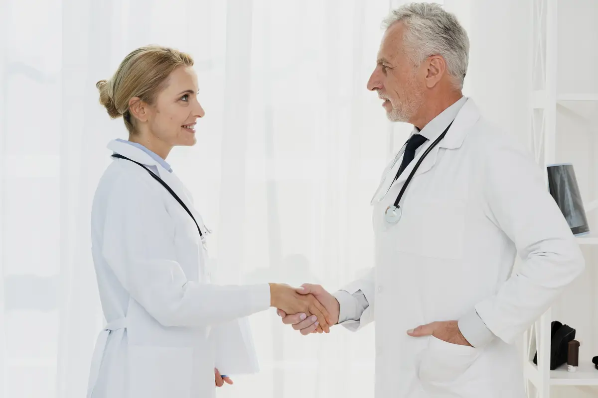 Doctors shaking hands side view