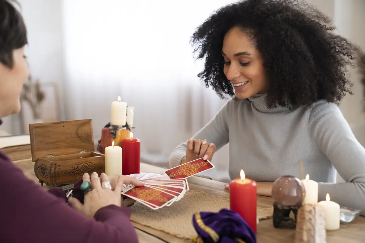Side view young woman reading tarot