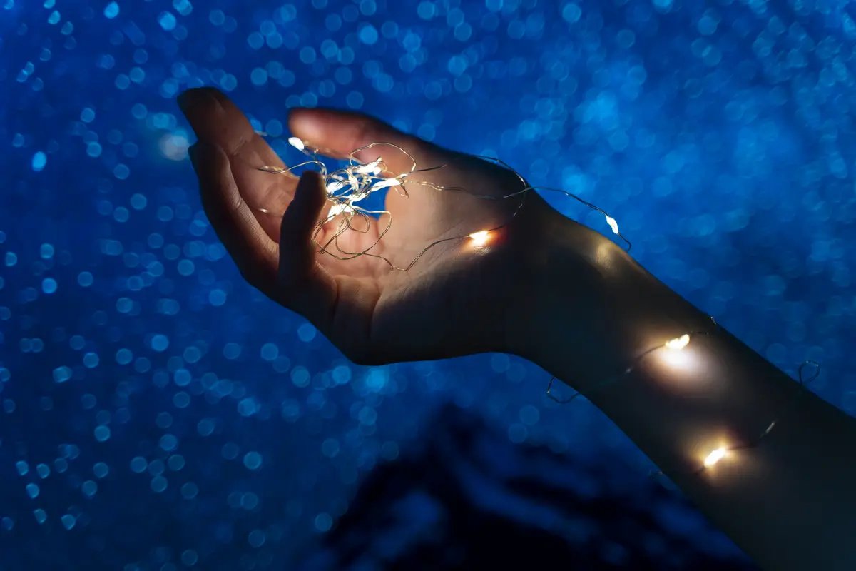 View of hands tiny lights