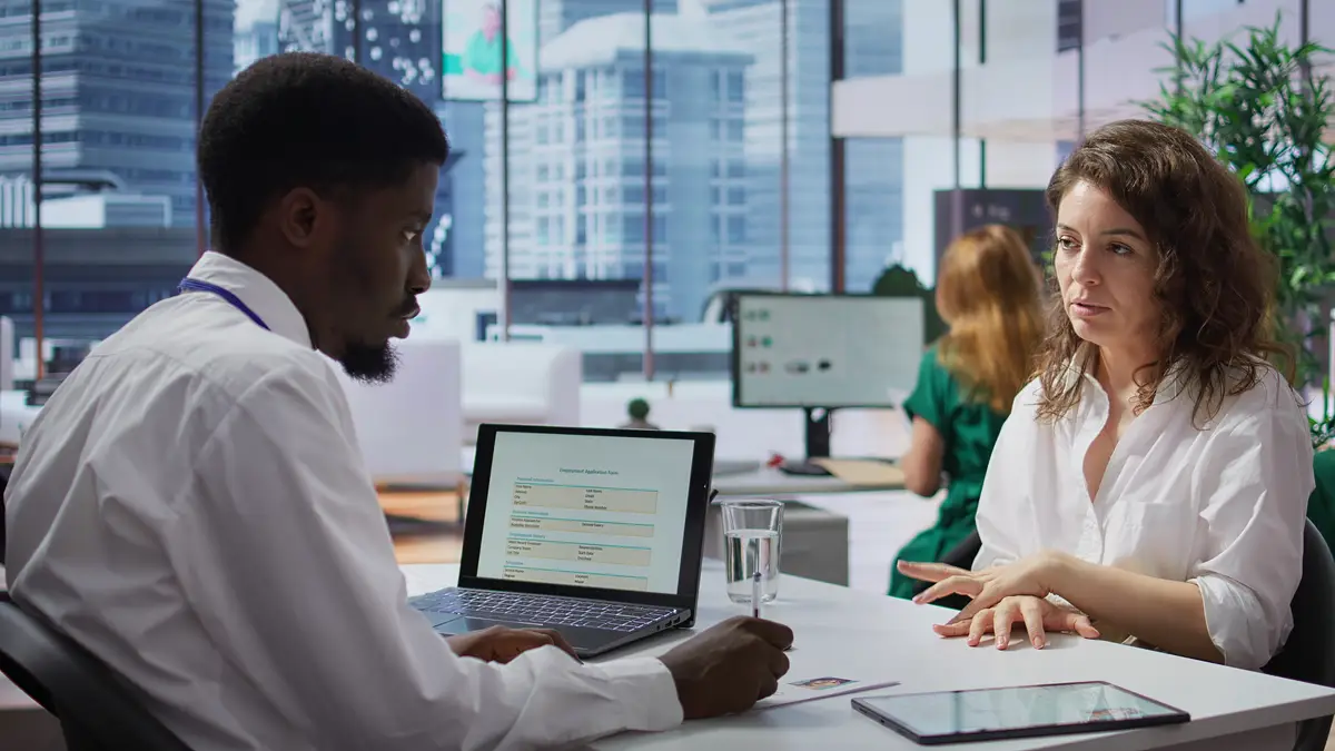 Staff interviewing woman applicant job seeker in high end office