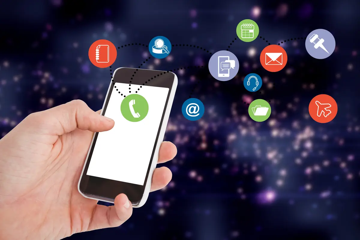 Close-up of hand holding a smartphone with colorful app icons