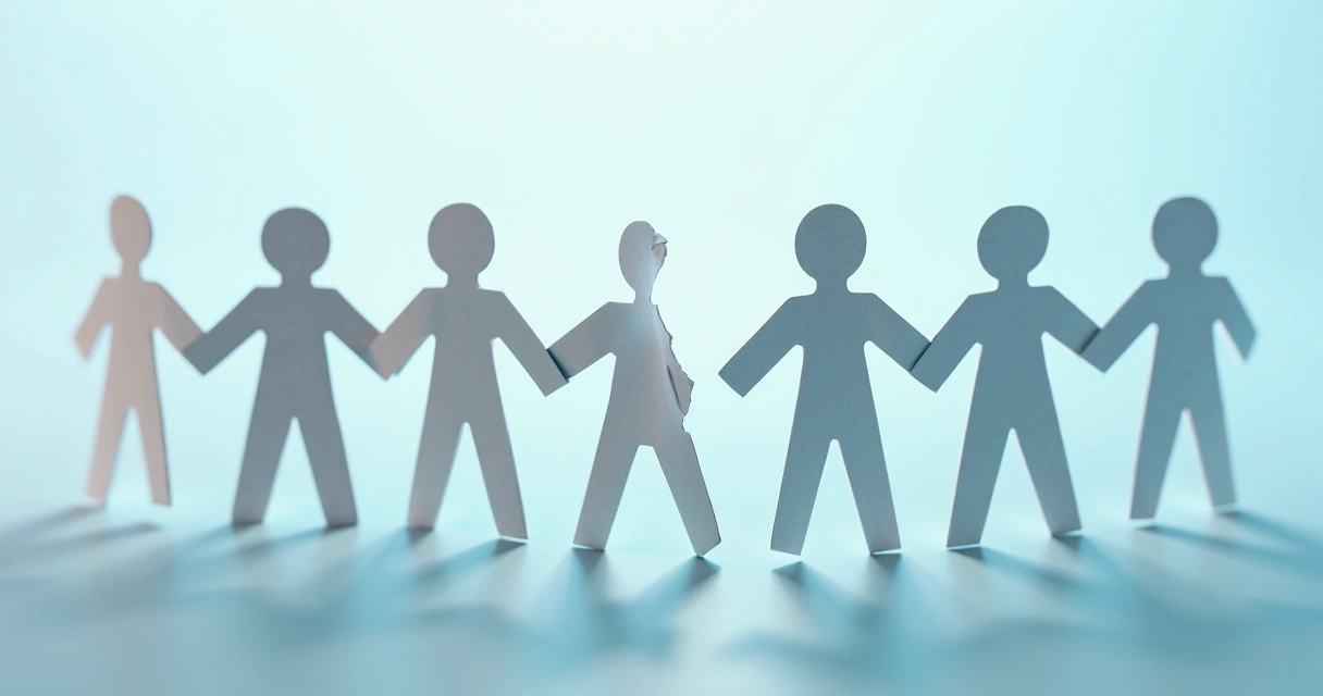 Paper chain people with one link broken apart 