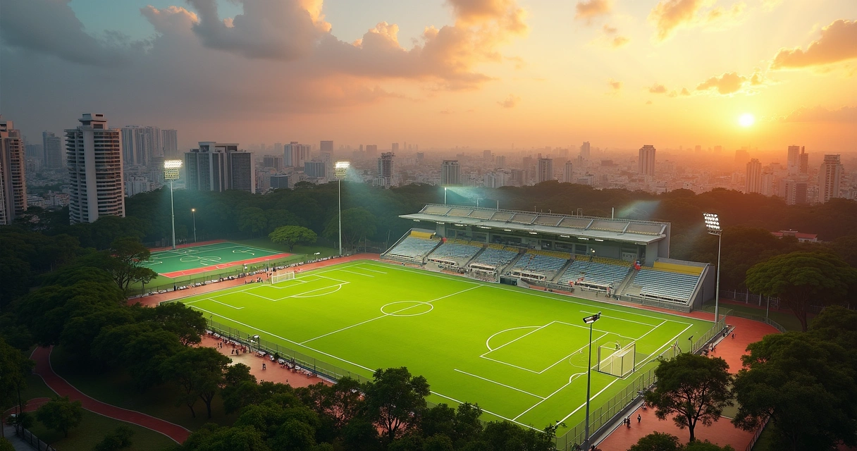 Complexo esportivo municipal com campo de futebol, ginásio e quadras ao pôr do sol 