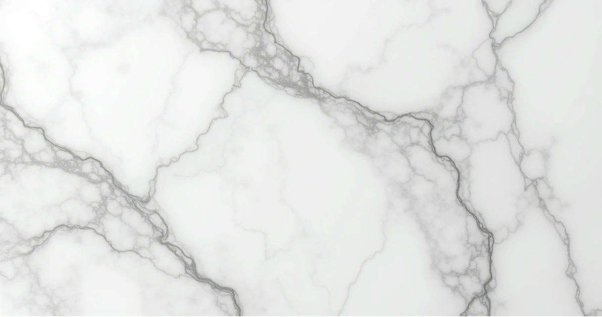 Detalhe do mármore Carrara com veios acinzentados sob superfície branca. 