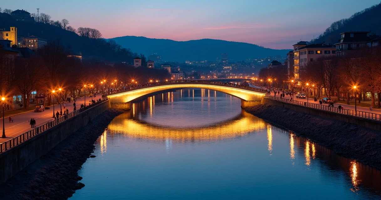 Ponte moderna iluminada sobre o rio em Tbilisi ao pôr do sol 